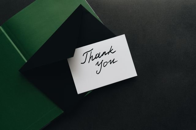 Minimalist thank you card with green envelope, perfect for expressing gratitude.